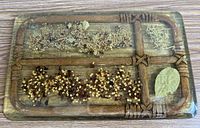 Top view of rectangular resin trivet showing embedded herbs, spices and faux wood lattice