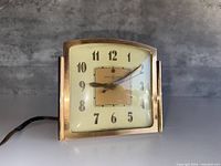 Front view of GE electric shelf clock showing full dial and case