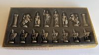 boxed chess set with clear lid showing 16 bright and 16 dark silver pieces