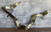 Full view of brass bird sculpture