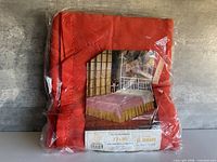 Blanket in sealed plastic showing overall appearance and color