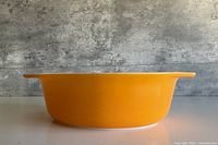 Side profile showing orange exterior and integrated handle