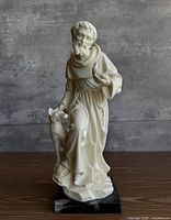 Full view of signed St. Francis sculpture on marble base