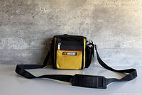 Front view of yellow and black NASCAR camera bag with shoulder strap