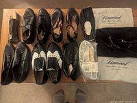 All seven pairs of dance shoes with Diamant cloth bags and Bleyer packaged slippers visible