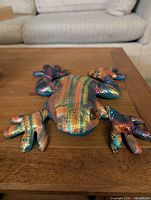 Top view of metallic rainbow bean bag frog plush on table