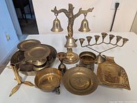 All brass items grouped on tabletop showing quantity and variety