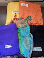 Group view of five pashmina scarves in assorted colours