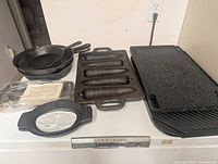 Overview of all cast iron pieces on countertop