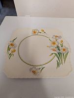 Front view of square floral plate with flower motif