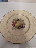 Front view showing embossed border, gold rim and fruit centre