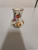 Front angled view of floral ceramic mini vase