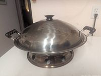 wok assembled with lid on stand