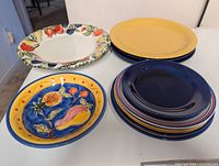 Group of fruit-rim platter, yellow plate stack, multi-colour plate stack, blue fruit plate
