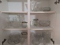 Cabinet shelves showing full assortment of crystal pieces