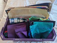 Tray containing assorted placemats and cloth napkins