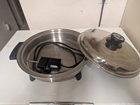 Electric frying pan with lid ajar showing probe inside