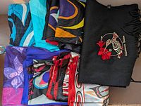 Group of eight Indigenous design scarves laid out