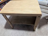 Table shown with leaves folded, front and shelf visible