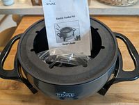Rival electric fondue pot with owner’s guide and cord inside