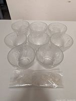 Eight grape-pattern punch cups with bagged plastic hooks