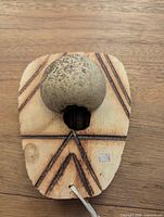 Reverse showing gourd resonator on wooden board