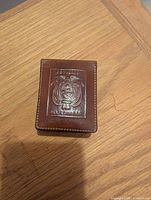 Front view showing embossed Republic of Ecuador emblem and stitching