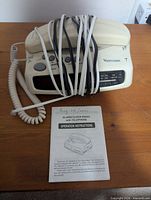 Venturer telephone clock radio with coiled handset cord and manual
