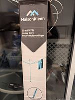 Boxed MaisonKleen rotary outdoor dryer showing branding and specifications