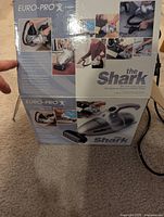 Retail box for Shark Euro-Pro X handheld vacuum showing product images and specifications