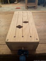 wooden tongue drum with slotted top and mallet holder