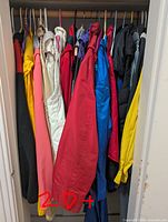 Closet view of assorted women’s jackets and coats, various colours, approximate count over 20