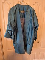 Teal silk blazer front view on hanger