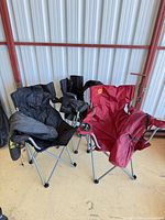 Three folding camp chairs side-by-side