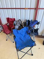 Group shot of four folding camping chairs showing colors and styles