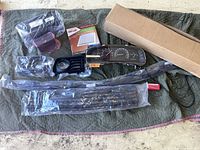 All items laid out: instrument cluster, box with air filter, red-edged filter element, valve, valance, grille