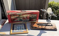 All four aviation items grouped: boxed RC helicopter, framed stamp sheet, carved plaque, airplane lamp