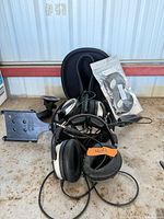 Two Lightspeed headsets, RAM mount, bagged ear cushions on table