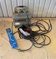 Full view of compressor, hoses, packaged inflator wand and bag