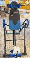 Front view of assembled Pooboo inversion table showing frame, padding and handlebars