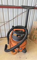 Full view of Ridgid wet/dry vac with hose and wand