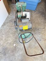 Full view of compressor showing tank, handle, wheels and twin-cylinder head