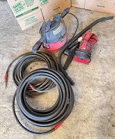 Overall lot showing Craftsman shop vac, Dirt Devil hand vac, coiled pressure hoses, hose nozzle