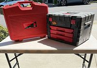 Closed red carry case beside black/red Craftsman 3-drawer toolbox