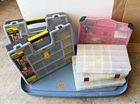Overall view of two Stanley SortMaster cases, pink organizer and three clear compartment boxes on blue tray