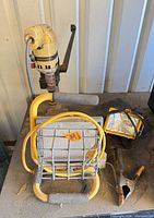 Drill, work light on stand, cables visible