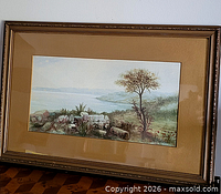 Front view of framed watercolor landscape in gold frame