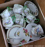Box containing assorted cups and saucers