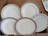 Group of six dinner plates in box