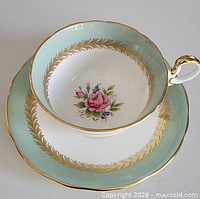Teacup inside saucer showing floral centre and border details